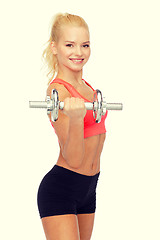 Image showing young sporty woman with heavy steel dumbbell