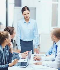 Image showing strict female boss talking to business team