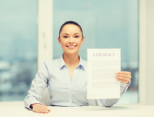 Image showing happy businesswoman holding contract in office