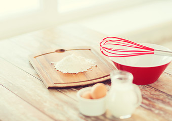 Image showing jugful of milk, eggs in a bowl and flour