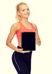 Image showing smiling woman showing tablet pc blank screen