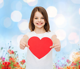 Image showing smiling little girl with red heart