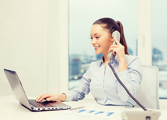 Image showing businesswoman with phone, laptop and files