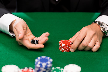 Image showing poker player with dice and chips at casino