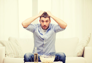 Image showing sad man watching sports at home