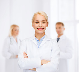 Image showing smiling female doctor with group of medics