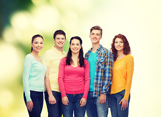 Image showing group of smiling teenagers over green background