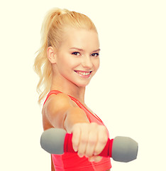 Image showing smiling beautiful sporty woman with dumbbell