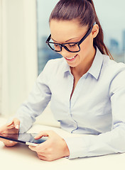 Image showing smiling businesswoman in eyeglasses with tablet pc