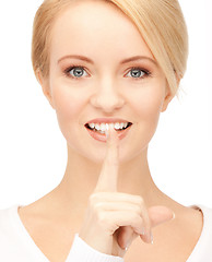 Image showing happy woman with finger on lips