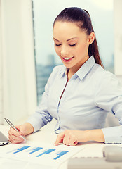 Image showing businesswoman with phone, laptop and files