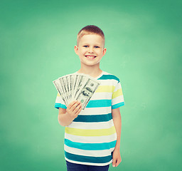 Image showing smiling boy holding dollar cash money in his hand