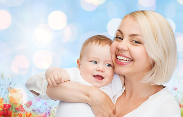 Image showing happy mother with baby over natural background