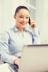 Image showing smiling businesswoman with laptop