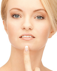 Image showing beautiful woman pointing to chin