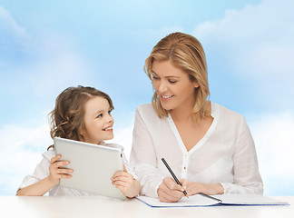 Image showing woman with notebook and girl holding tablet pc 