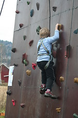 Image showing Boy climbing a wall