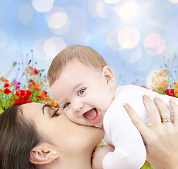 Image showing happy mother with baby over natural background