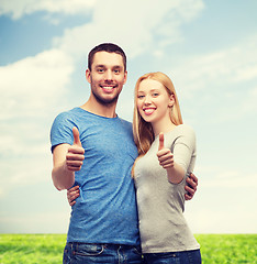 Image showing smiling couple showing thumbs up