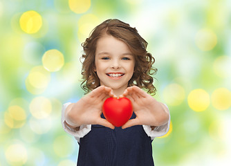 Image showing smiling little girl with red heart