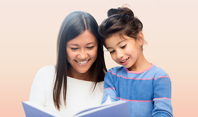 Image showing happy mother and daughter reading book