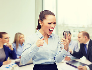 Image showing screaming businesswoman with smartphone