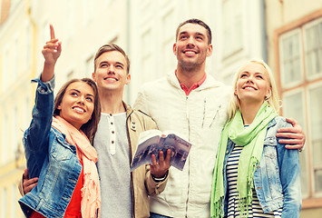 Image showing group of friends with city guide exploring town