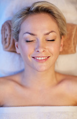 Image showing close up of smiling young woman lying in spa