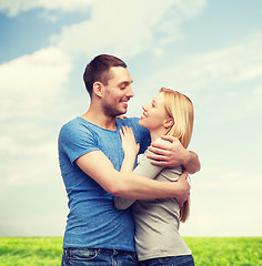 Image showing smiling couple hugging and looking at each other