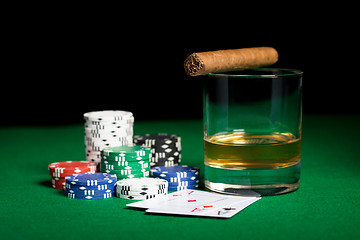 Image showing close up of chips, cards whisky and cigar on table