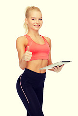 Image showing smiling sporty woman with tablet pc computer