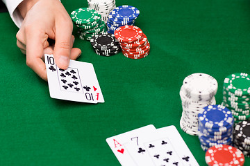 Image showing poker player with cards and chips at casino