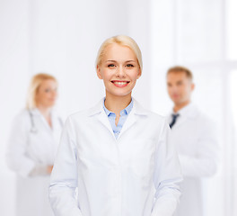 Image showing smiling female doctor with group of medics