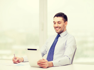 Image showing smiling businessman with tablet pc and documents