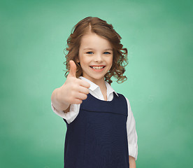 Image showing happy little school girl showing thumbs up