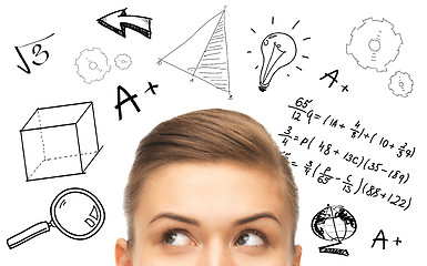 Image showing close up of woman looking to mathematical doodles