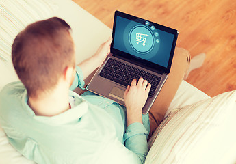 Image showing close up of man working with laptop at home