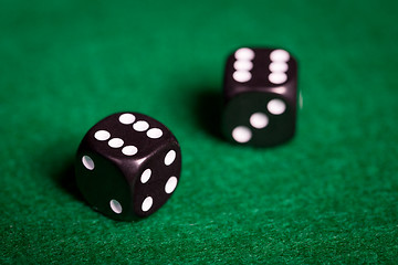 Image showing close up of black dice on green casino table