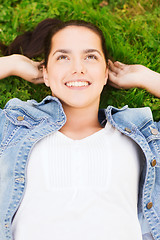 Image showing smiling young girl lying on grass