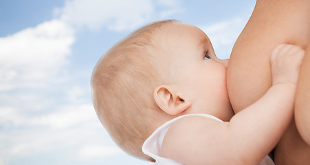 Image showing close up of mother breast feeding adorable baby