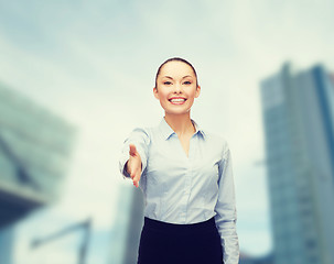 Image showing businesswoman with opened hand ready for handshake