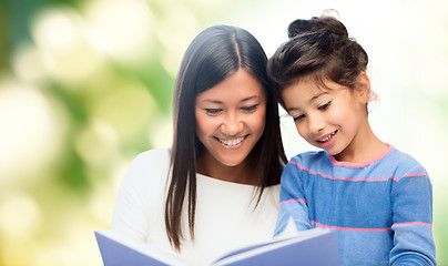 Image showing happy mother and daughter reading book