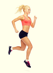 Image showing sporty woman running or jumping