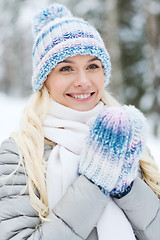 Image showing smiling young woman in winter forest