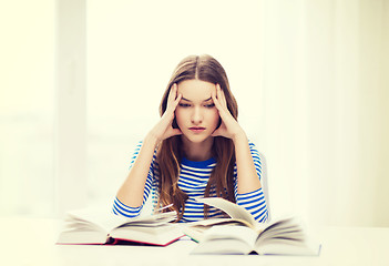 Image showing stressed student girl with books
