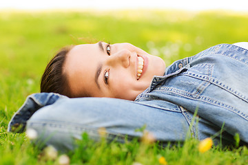 Image showing smiling young girl lying on grass