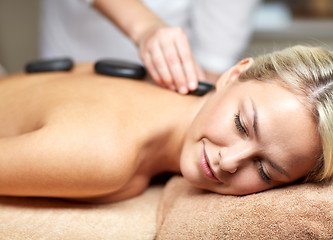 Image showing close up of woman having hot stone massage in spa