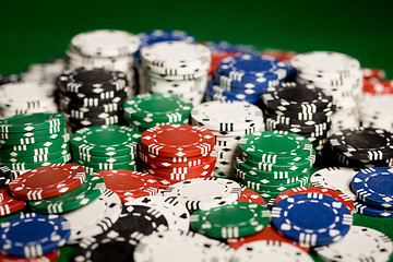 Image showing close up of casino chips on green table surface