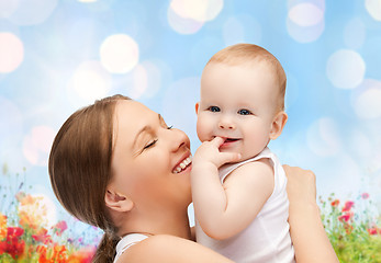 Image showing happy mother with baby over natural background