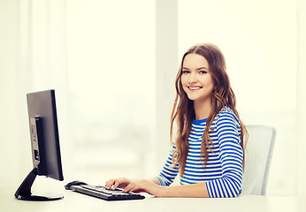 Image showing dreaming teenage girl with computer at home